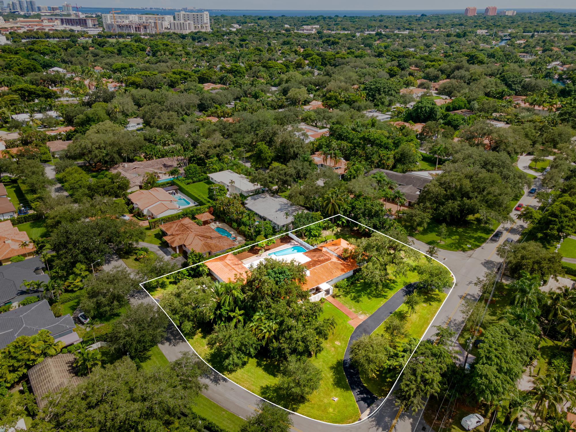 Aerial view of 4209 Granada Boulevard, with landscaped grounds and pool